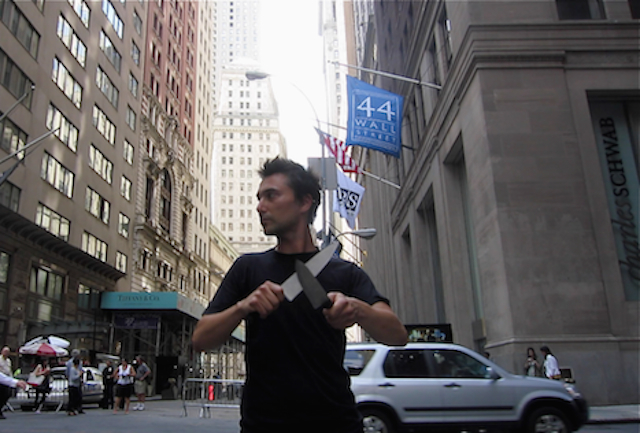 "Sharpening " 2012. Performance. Wall Street, First Police block barricade- Security Zone in Financial district. NYC, US